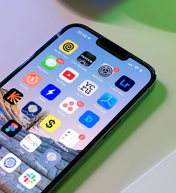 Smartphone displaying various app icons created by a mobile app development company